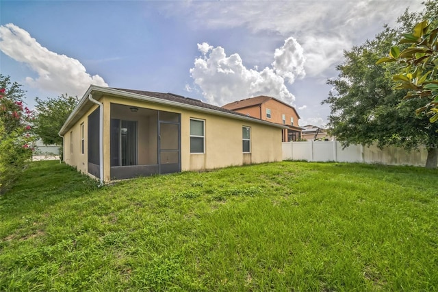 236 Savannah Preserve Loop, Davenport, FL 33837 - rear view of property featuring a sunroom and stucco siding