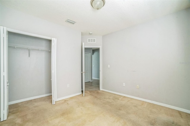 236 Savannah Preserve Loop, Davenport, FL 33837 - unfurnished bedroom featuring light carpet, a closet, and baseboards