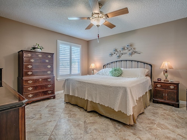 1206 Thompson Ave, The Villages, FL 32162 - bedroom featuring a textured ceiling, ceiling fan, light stone finish flooring, and baseboards