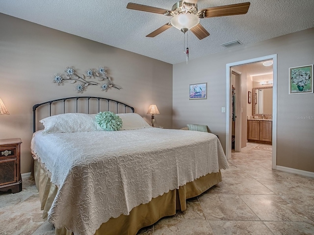 1206 Thompson Ave, The Villages, FL 32162 - bedroom featuring baseboards, a ceiling fan, a sink, a textured ceiling, and light stone finish floors