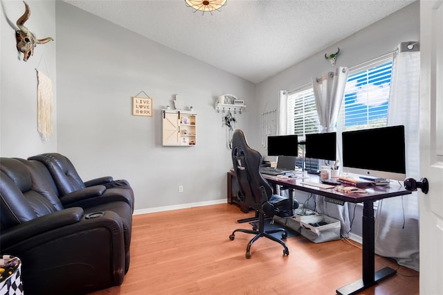 1311 Rain Forest Ln, Minneola, FL 34715 - office featuring wood finished floors, vaulted ceiling, and a textured ceiling