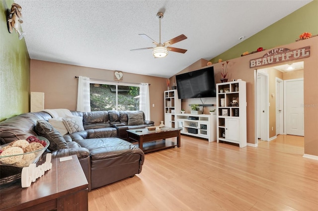 1311 Rain Forest Ln, Minneola, FL 34715 - living room featuring a ceiling fan, wood finished floors, vaulted ceiling, and a textured ceiling
