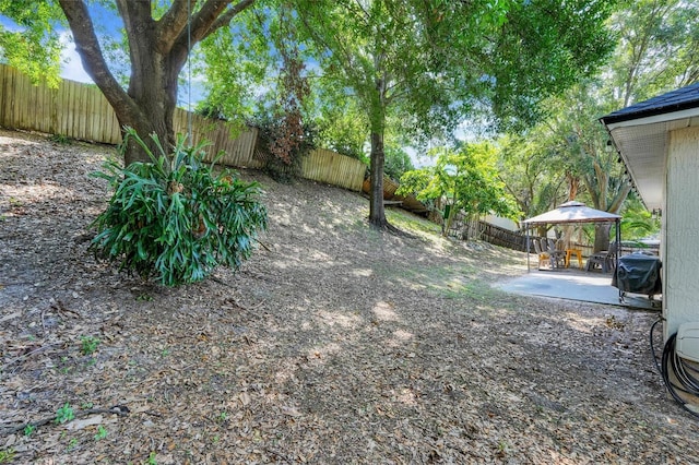 1311 Rain Forest Ln, Minneola, FL 34715 - fenced backyard with a gazebo and a patio