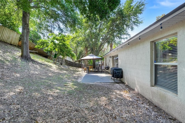 1311 Rain Forest Ln, Minneola, FL 34715 - fenced backyard with a gazebo and a patio area