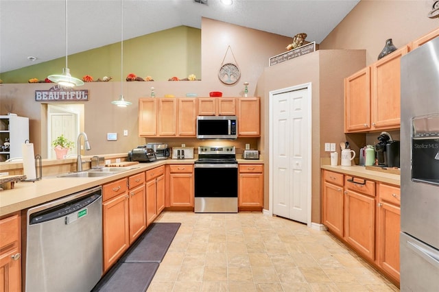 1311 Rain Forest Ln, Minneola, FL 34715 - kitchen with appliances with stainless steel finishes, high vaulted ceiling, light countertops, decorative light fixtures, and light brown cabinets