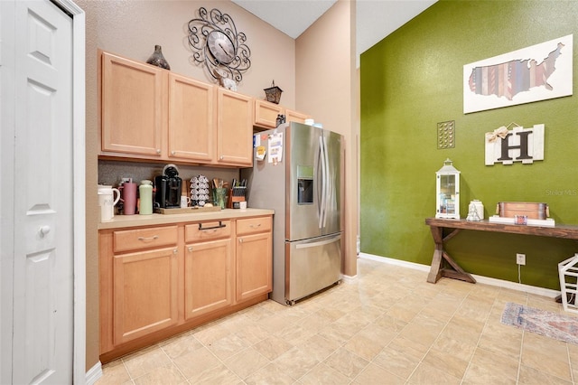 1311 Rain Forest Ln, Minneola, FL 34715 - kitchen with stainless steel fridge, light brown cabinets, light countertops, and a high ceiling