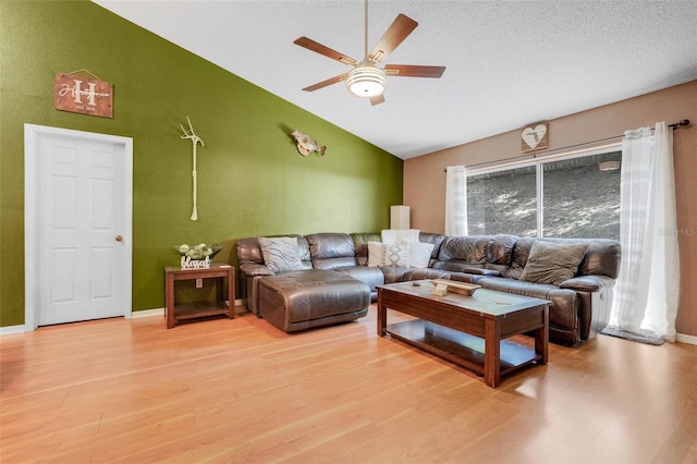 1311 Rain Forest Ln, Minneola, FL 34715 - living area featuring vaulted ceiling, ceiling fan, and light wood finished floors