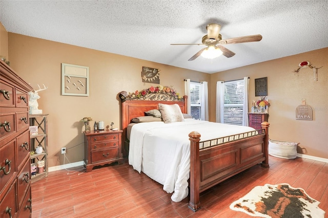 1311 Rain Forest Ln, Minneola, FL 34715 - bedroom with light wood finished floors, ceiling fan, and a textured ceiling