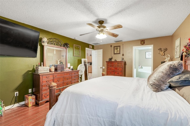 1311 Rain Forest Ln, Minneola, FL 34715 - bedroom with wood finished floors, a textured ceiling, and a ceiling fan