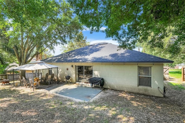 1311 Rain Forest Ln, Minneola, FL 34715 - rear view of house with a gazebo, roof with shingles, and a patio area