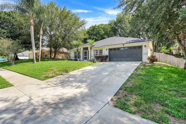 1311 Rain Forest Ln, Minneola, FL 34715 - ranch-style house with driveway, an attached garage, and stucco siding