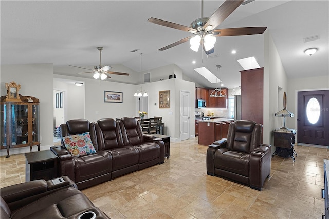 living area featuring ceiling fan, stone tile floors, vaulted ceiling, healthy amount of natural light, and recessed lighting