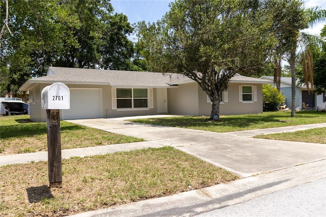 2701 S Dellwood Dr, Eustis, FL 32726 - single story home with an attached garage, concrete driveway, stucco siding, and a front yard
