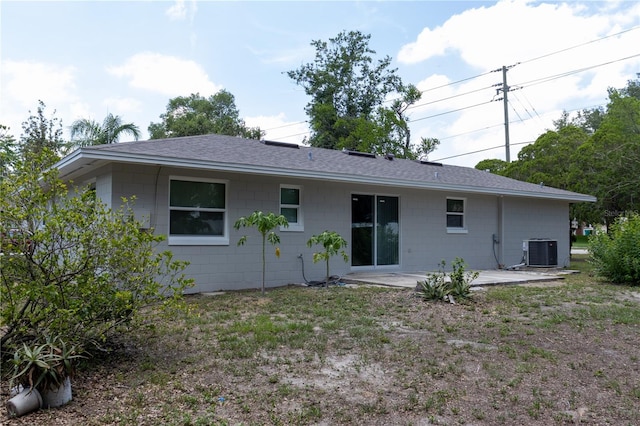 2701 S Dellwood Dr, Eustis, FL 32726 - back of property featuring a patio area, concrete block siding, roof with shingles, and central AC unit