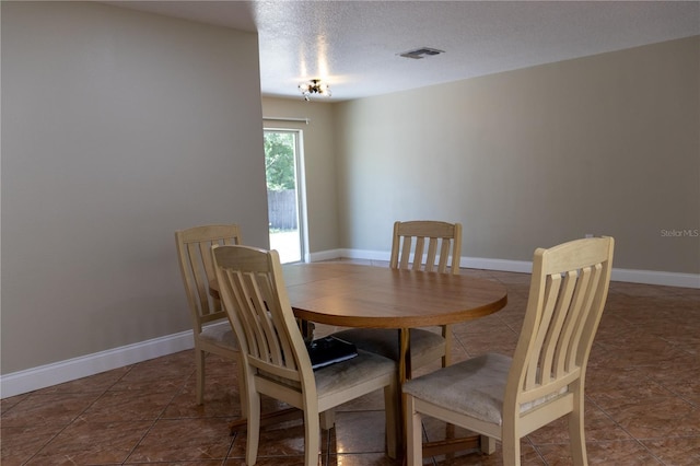 2701 S Dellwood Dr, Eustis, FL 32726 - tiled dining area featuring baseboards and a textured ceiling