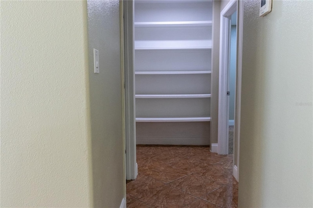 2701 S Dellwood Dr, Eustis, FL 32726 - corridor with dark tile patterned flooring