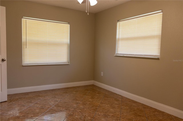 2701 S Dellwood Dr, Eustis, FL 32726 - empty room featuring a ceiling fan, healthy amount of natural light, and baseboards