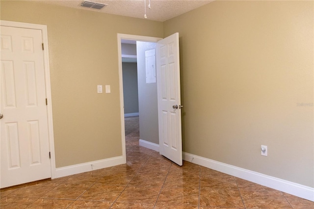 2701 S Dellwood Dr, Eustis, FL 32726 - spare room featuring a textured ceiling and baseboards