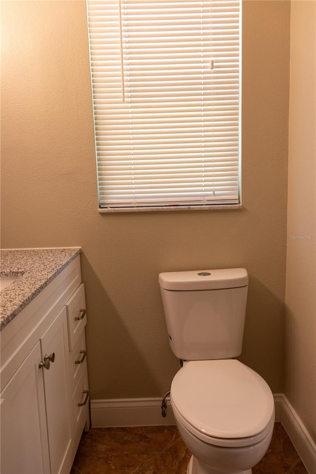 2701 S Dellwood Dr, Eustis, FL 32726 - bathroom featuring baseboards, vanity, and toilet