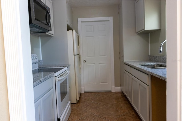 2701 S Dellwood Dr, Eustis, FL 32726 - kitchen featuring white appliances, a sink, and tile patterned floors