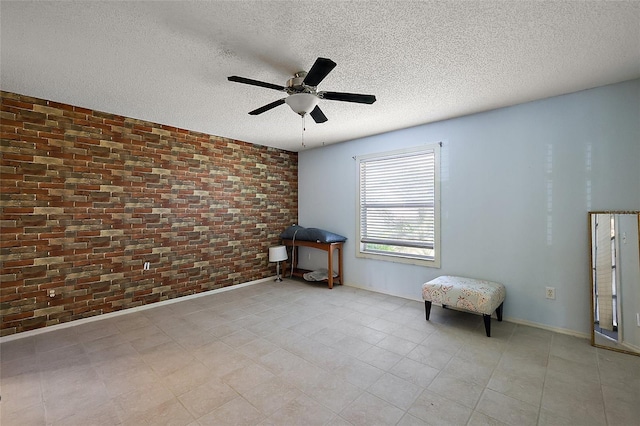 2003 Cordero Ct, The Villages, FL 32159 - empty room featuring brick wall, a ceiling fan, a textured ceiling, and light tile patterned flooring