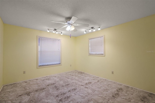 2003 Cordero Ct, The Villages, FL 32159 - empty room featuring rail lighting, a ceiling fan, and carpet flooring