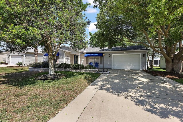 2003 Cordero Ct, The Villages, FL 32159 - ranch-style house with an attached garage, driveway, and a front lawn