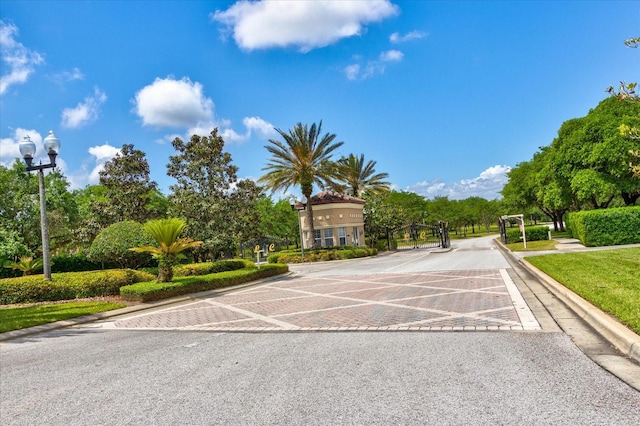 9307 San Jose Blvd, Howey In The Hills, FL 34737 - view of asphalt street featuring curbs, street lights, and a gated entry