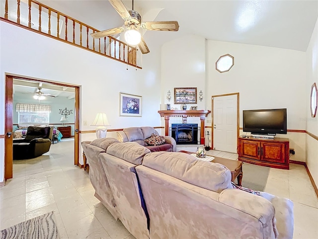 1107 Northshore Dr, Eustis, FL 32726 - living area with ceiling fan, high vaulted ceiling, a fireplace with raised hearth, and baseboards