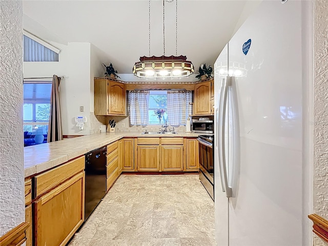 1107 Northshore Dr, Eustis, FL 32726 - kitchen with appliances with stainless steel finishes, a sink, and tile countertops