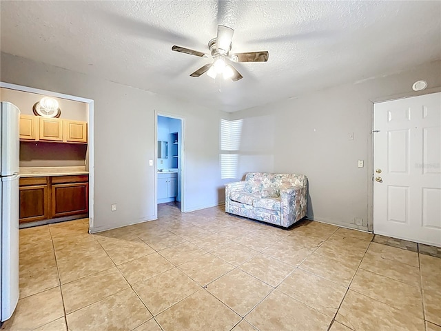 1107 Northshore Dr, Eustis, FL 32726 - living room featuring a ceiling fan, light tile patterned floors, and a textured ceiling