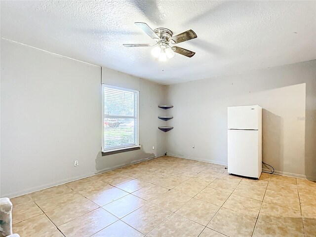 1107 Northshore Dr, Eustis, FL 32726 - empty room featuring ceiling fan, light tile patterned floors, a textured ceiling, and baseboards