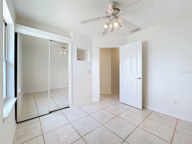 2024 Meadowside Dr, Eustis, FL 32726 - unfurnished bedroom featuring light tile patterned flooring, a closet, and a ceiling fan