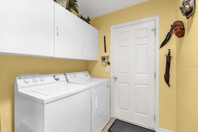 laundry area featuring washer and dryer and cabinet space