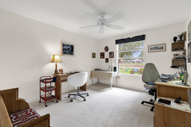 office area with carpet floors and a ceiling fan