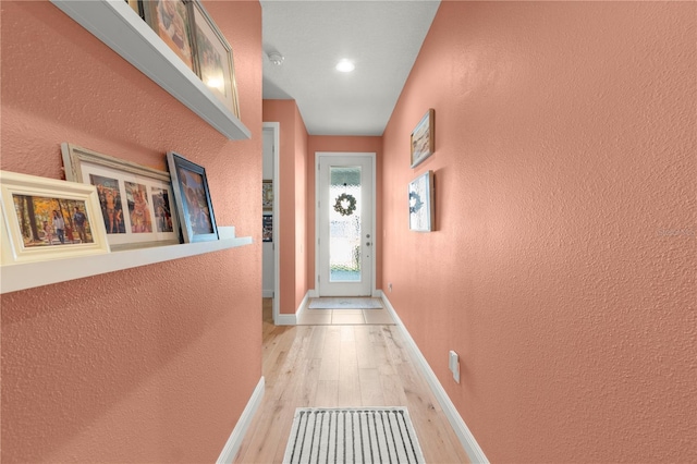2928 Marlberry Ln, Clermont, FL 34714 - doorway featuring a textured wall, light wood-style flooring, baseboards, and recessed lighting
