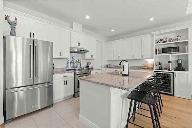 2928 Marlberry Ln, Clermont, FL 34714 - kitchen with appliances with stainless steel finishes, beverage cooler, under cabinet range hood, open shelves, and white cabinets