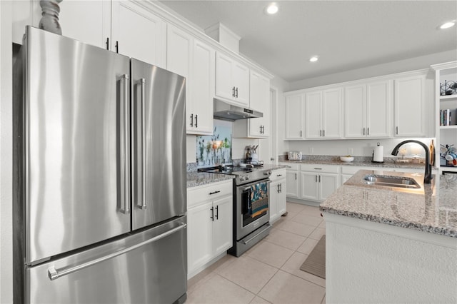 2928 Marlberry Ln, Clermont, FL 34714 - kitchen with stainless steel appliances, a sink, under cabinet range hood, white cabinets, and recessed lighting