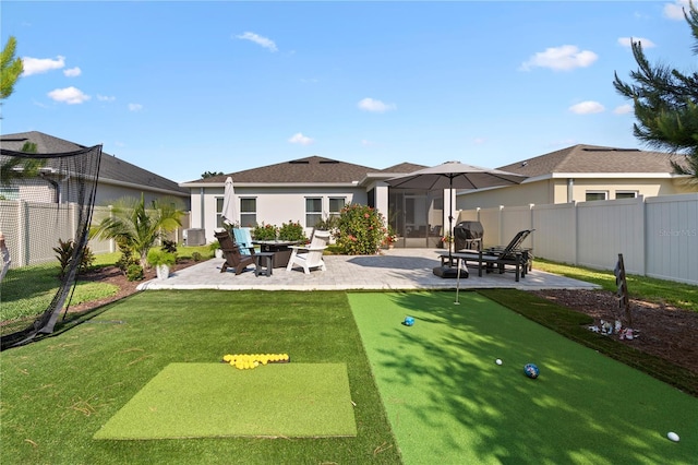 2928 Marlberry Ln, Clermont, FL 34714 - back of house featuring a patio, a putting green, an outdoor fire pit, and stucco siding