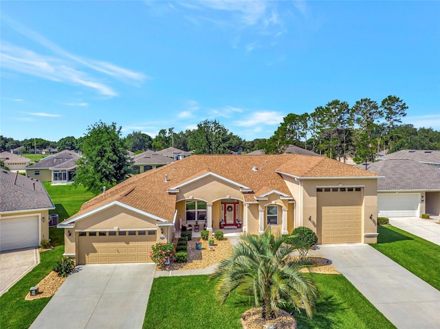 4716 Heritage Trl, Leesburg, FL 34748 - mediterranean / spanish home with stucco siding, a front lawn, concrete driveway, and a garage