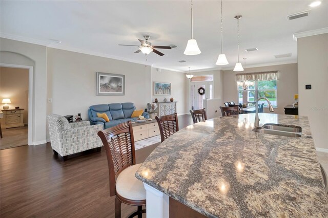 4716 Heritage Trl, Leesburg, FL 34748 - dining space featuring ornamental molding, a ceiling fan, dark wood-style flooring, and baseboards