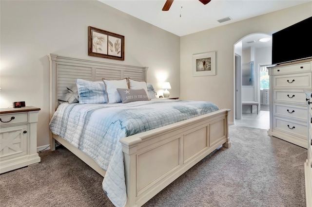 4716 Heritage Trl, Leesburg, FL 34748 - bedroom with arched walkways, light carpet, a ceiling fan, and baseboards