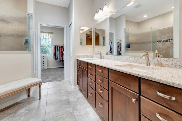 4716 Heritage Trl, Leesburg, FL 34748 - bathroom featuring a tile shower, double vanity, a spacious closet, and tile patterned flooring