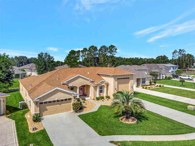 4716 Heritage Trl, Leesburg, FL 34748 - view of front of house featuring driveway, stucco siding, a garage, and a front yard