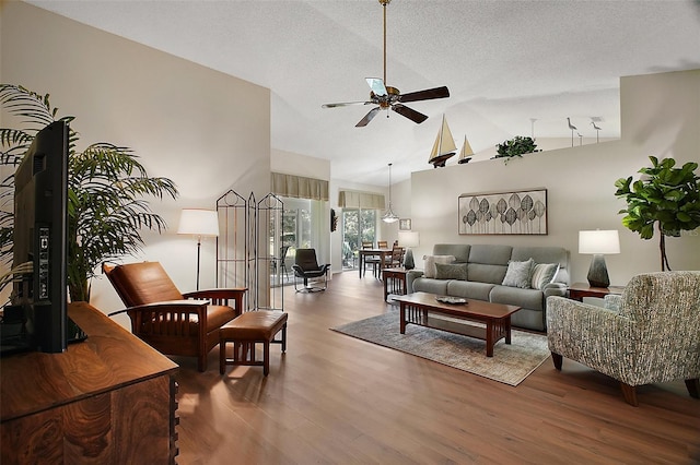 25406 Crestwater Dr, Leesburg, FL 34748 - living area featuring a ceiling fan, wood finished floors, vaulted ceiling, and a textured ceiling