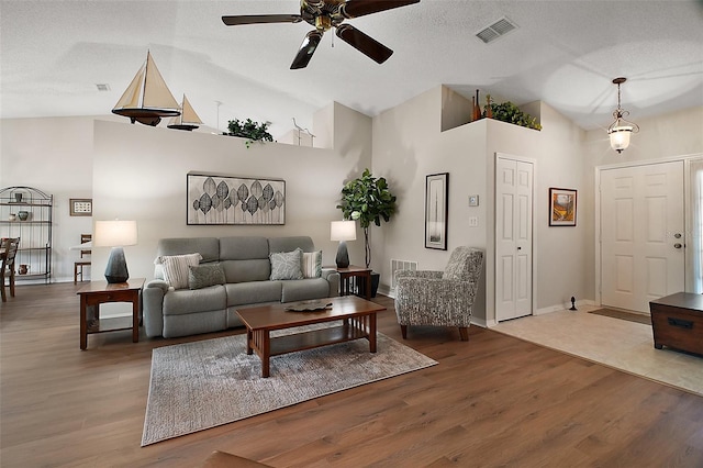 25406 Crestwater Dr, Leesburg, FL 34748 - living area featuring a ceiling fan, high vaulted ceiling, wood finished floors, and baseboards