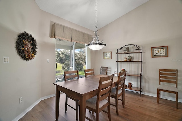 25406 Crestwater Dr, Leesburg, FL 34748 - dining area featuring wood finished floors, baseboards, and vaulted ceiling