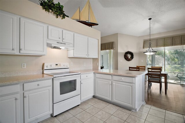 25406 Crestwater Dr, Leesburg, FL 34748 - kitchen with white electric stove, under cabinet range hood, white cabinets, and a textured ceiling