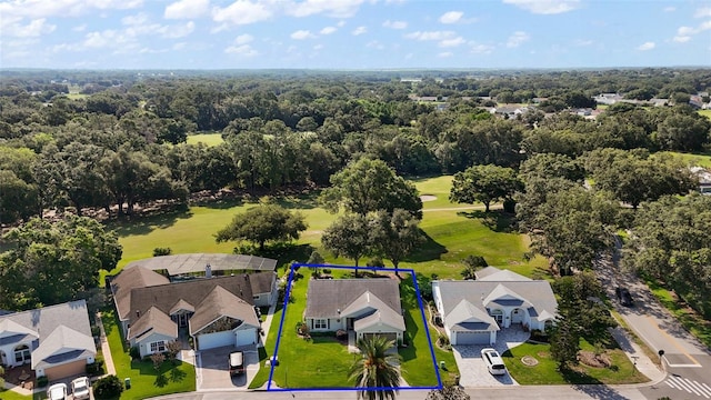 25406 Crestwater Dr, Leesburg, FL 34748 - aerial view of residential area featuring property parcel outlined, a golf course, and a heavily wooded area