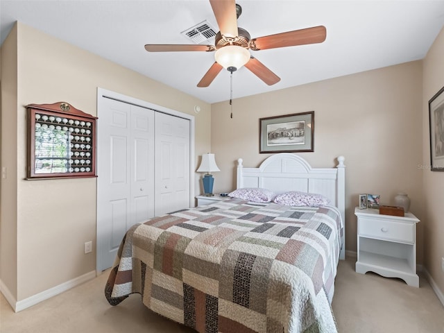 10986 SE 171st Street Rd, Summerfield, FL 34491 - bedroom featuring light colored carpet, a closet, baseboards, and a ceiling fan
